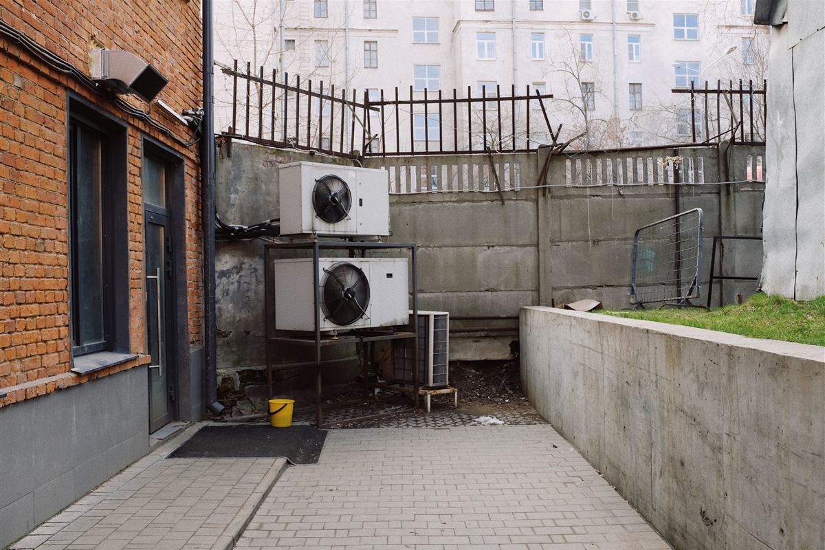Older heat pump outdoor unit weathered by years of service