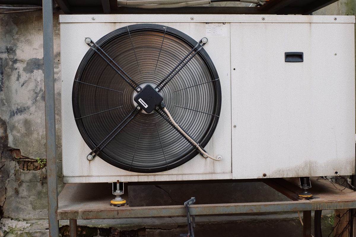 Close view of a large heat pump outdoor unit and its fan